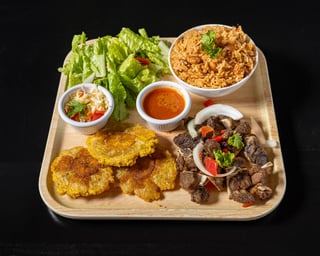 Fried Goat (served with plantain and 1 choice of white rice, rice and beans,  djondjon rice or  white rice and beans sauce)