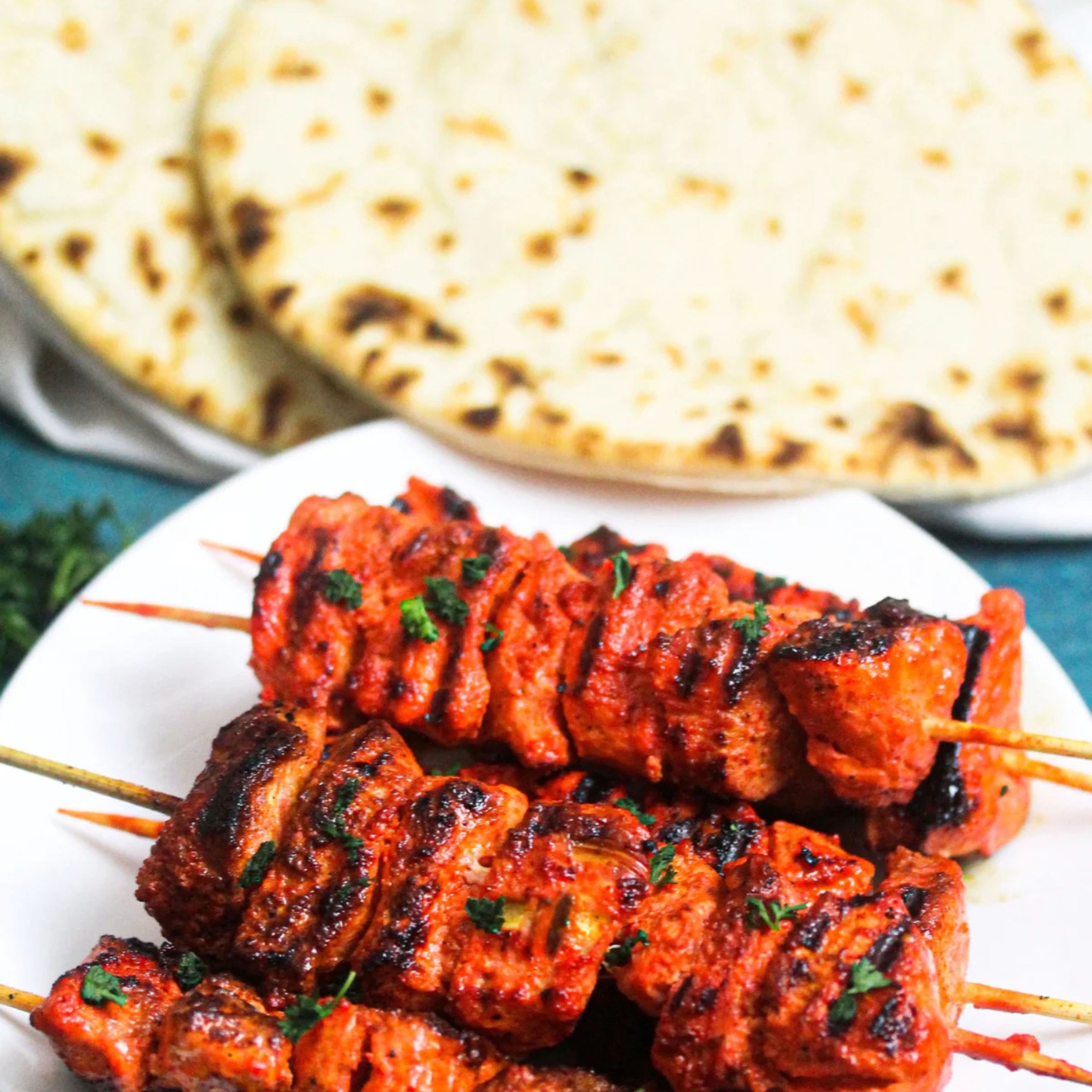 Tikka chicken in 2 skewers with Garlic Naan.