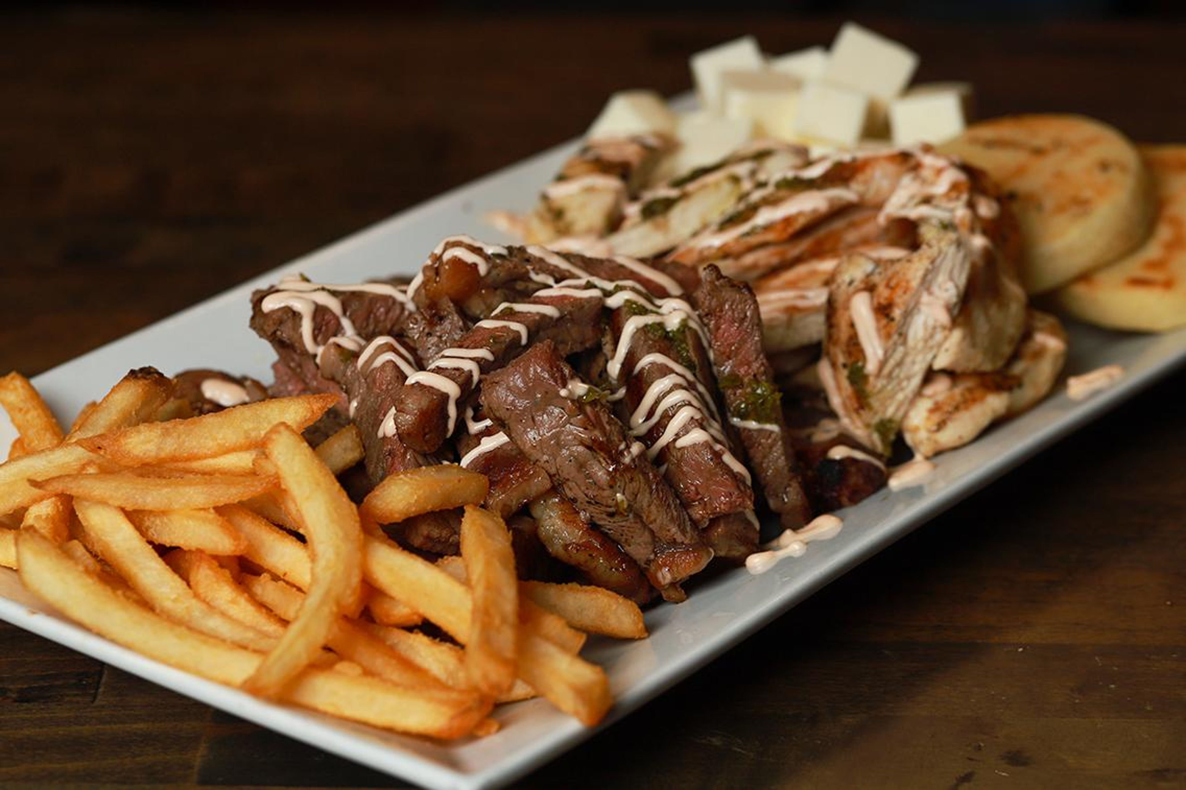 Grilled Beef Chicken and Sausage Platter.