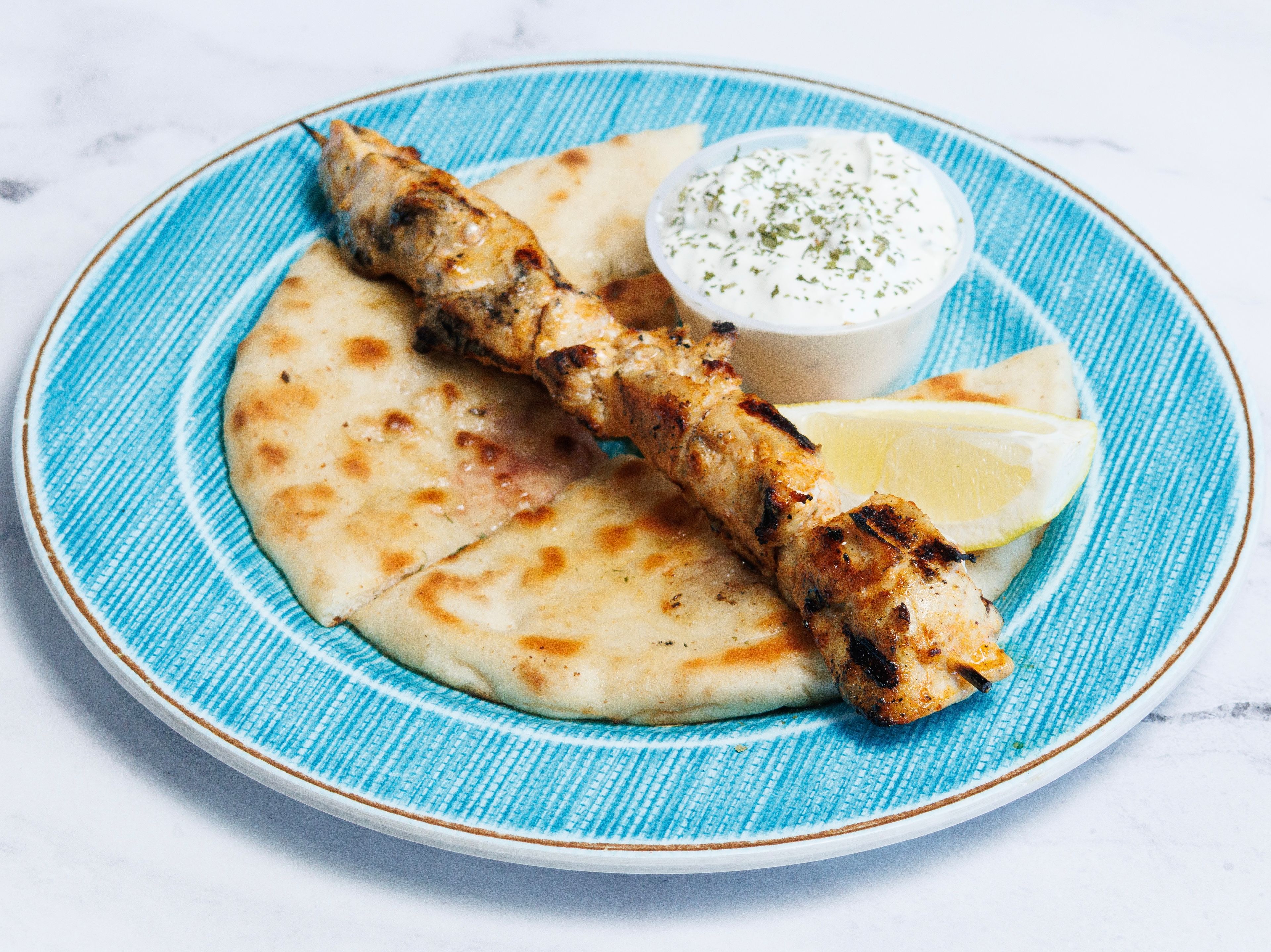 (1) CHICKEN SOUVLAKI SKEWER W/ PITA & TZATZIKI.