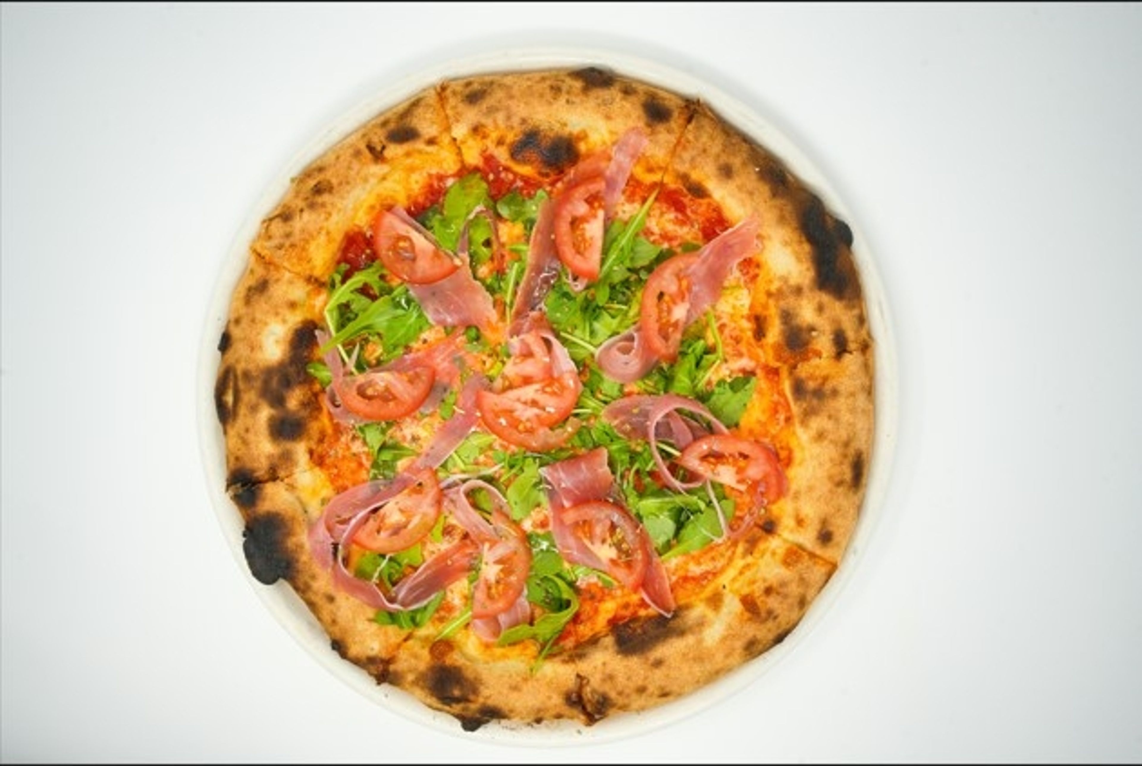 Prosciutto con arugula pizza.