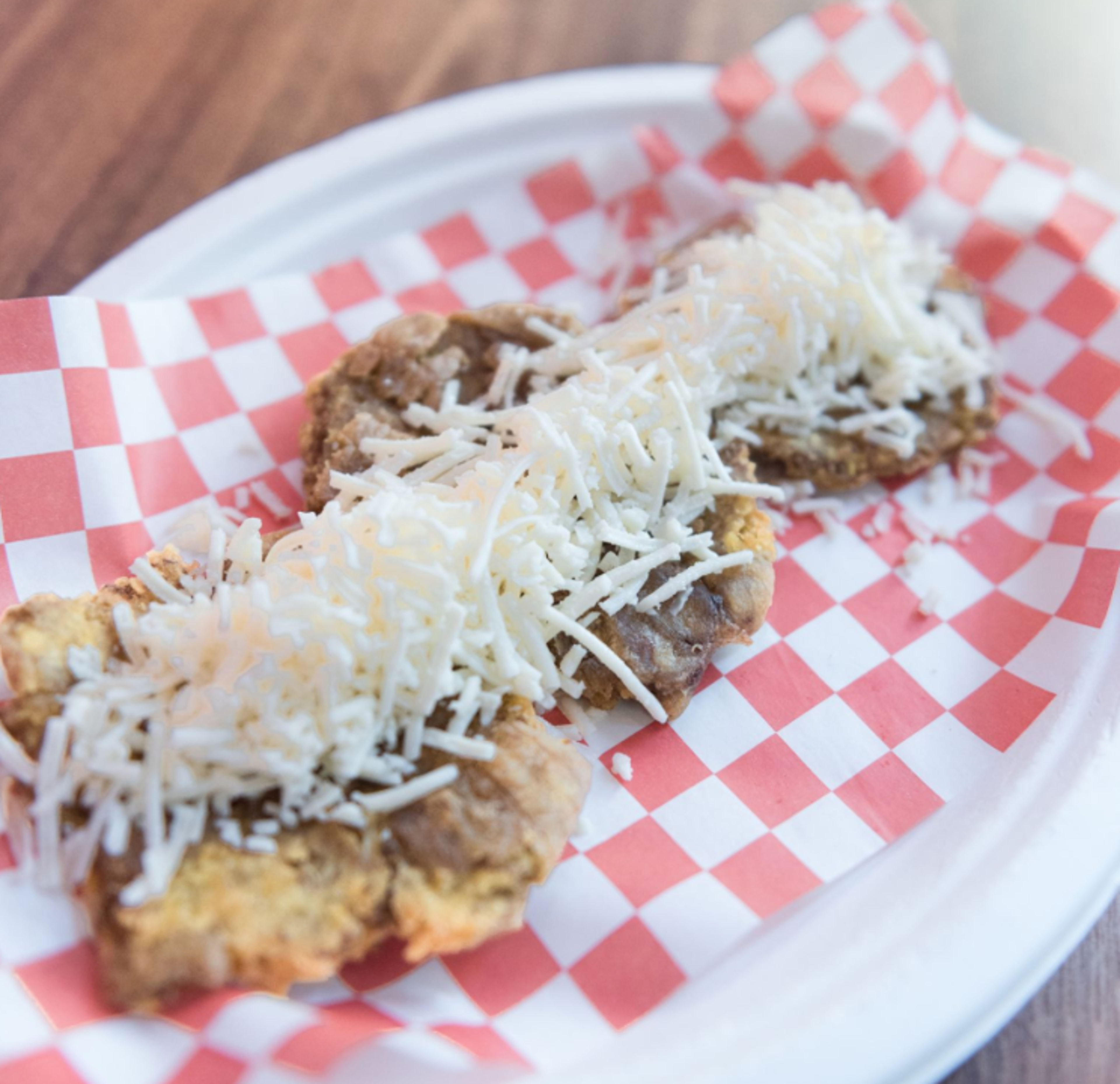 Patacones w/ White Shredded Cheese.