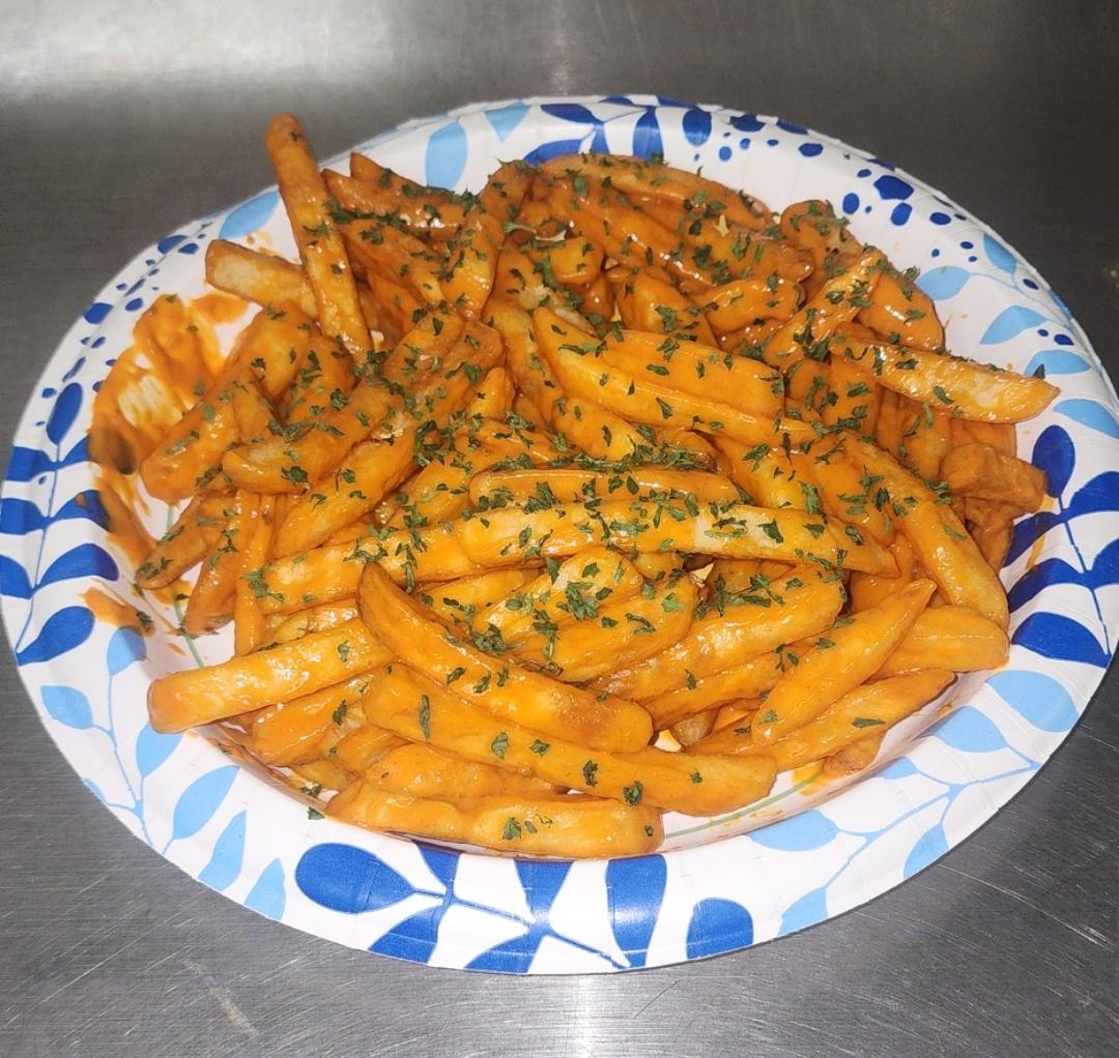GARLIC Buffalo  FRIES topped with parsley.