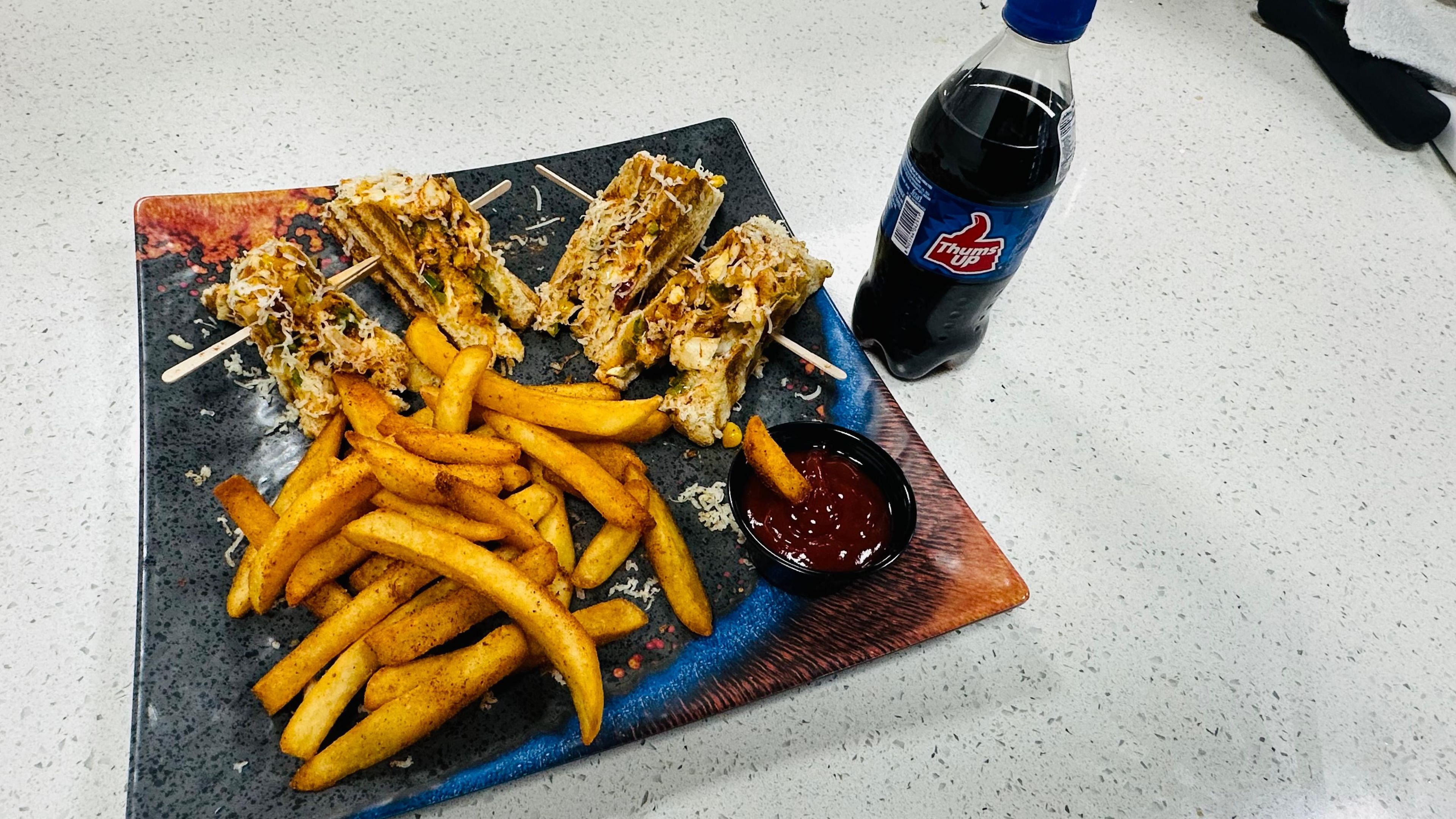 Singas Veg Club Sandwich with Fries.