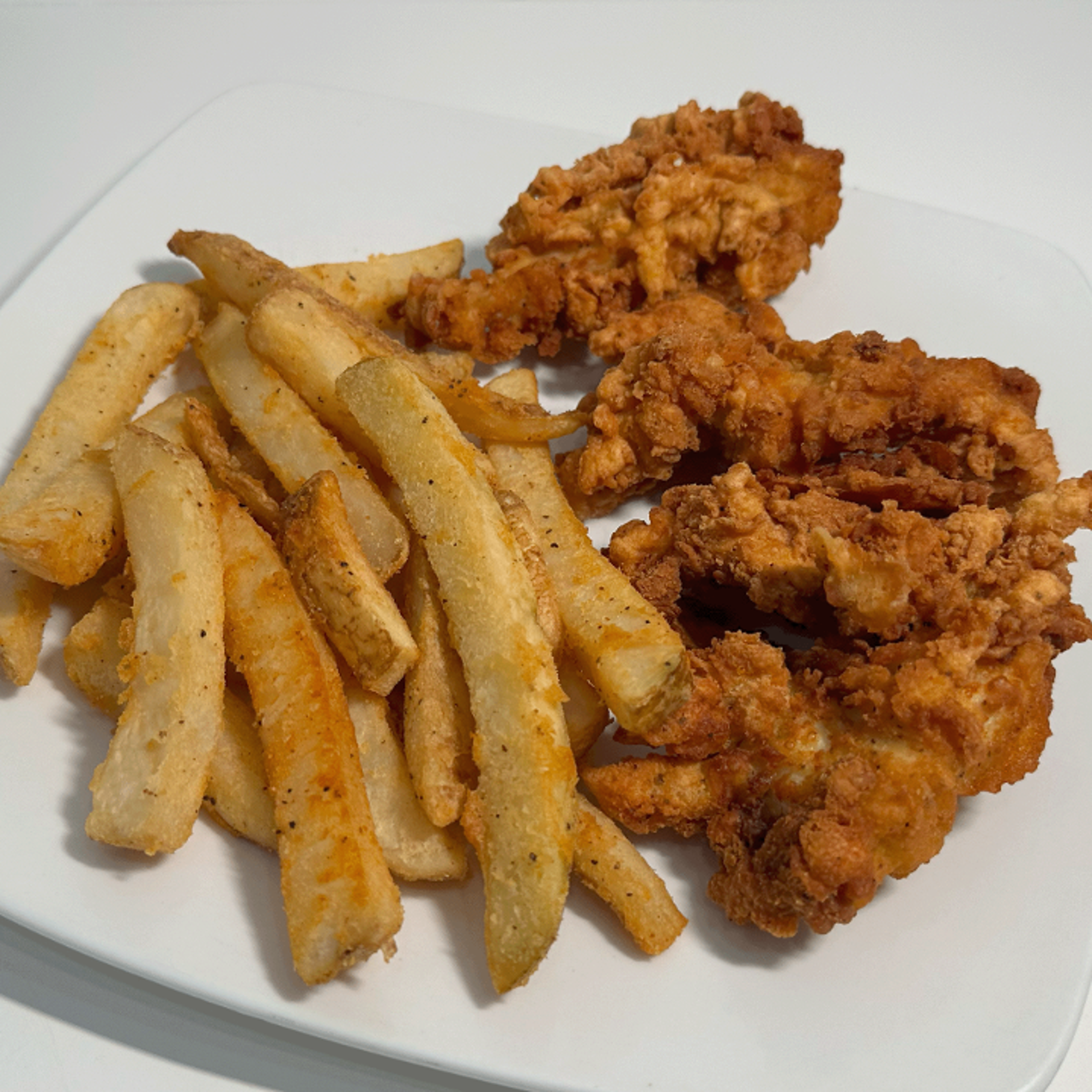 CHICKEN TENDERS AND FRENCH FRIES.