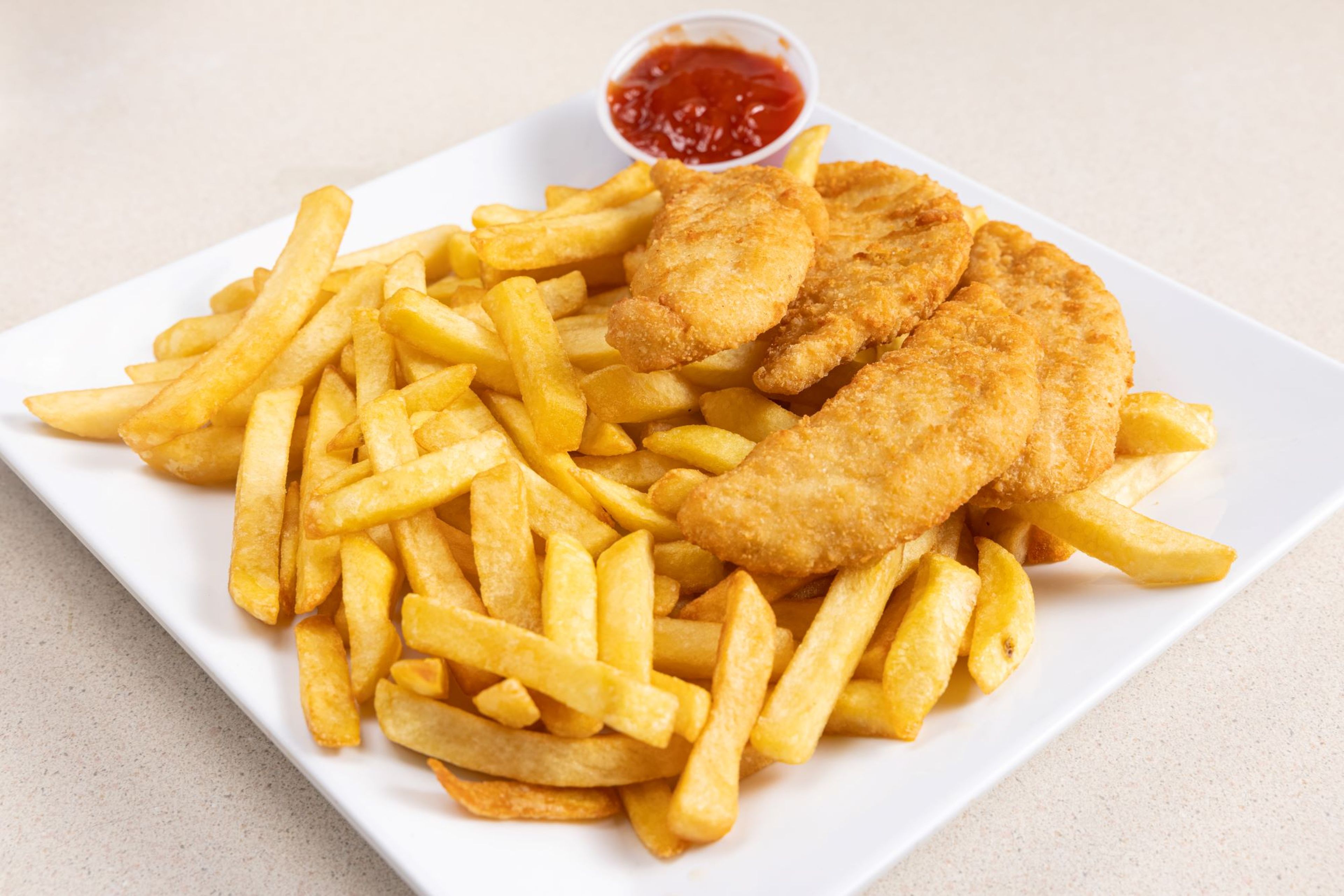 Chicken fingers with French fries.