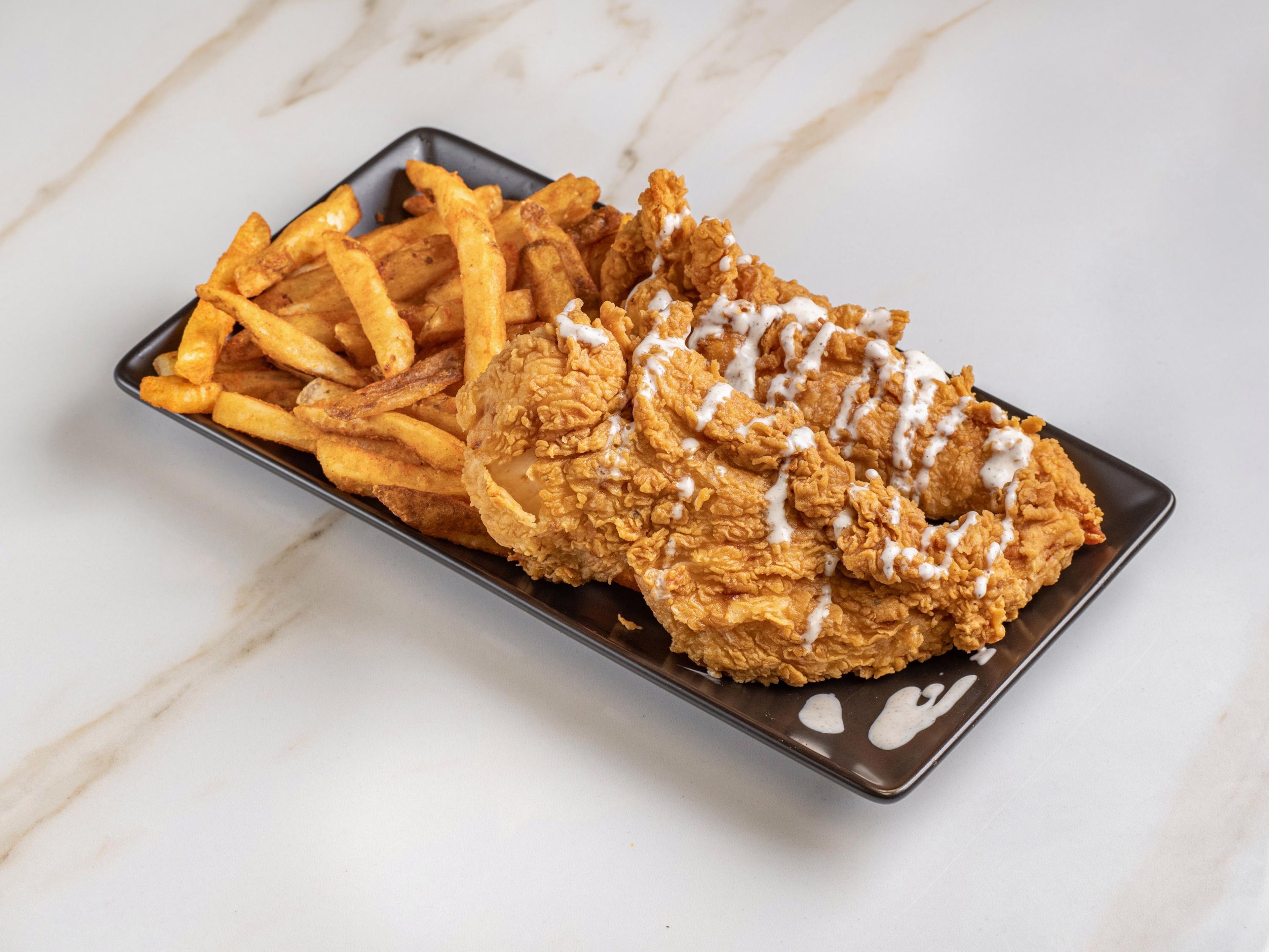 Fried Tender over fries.