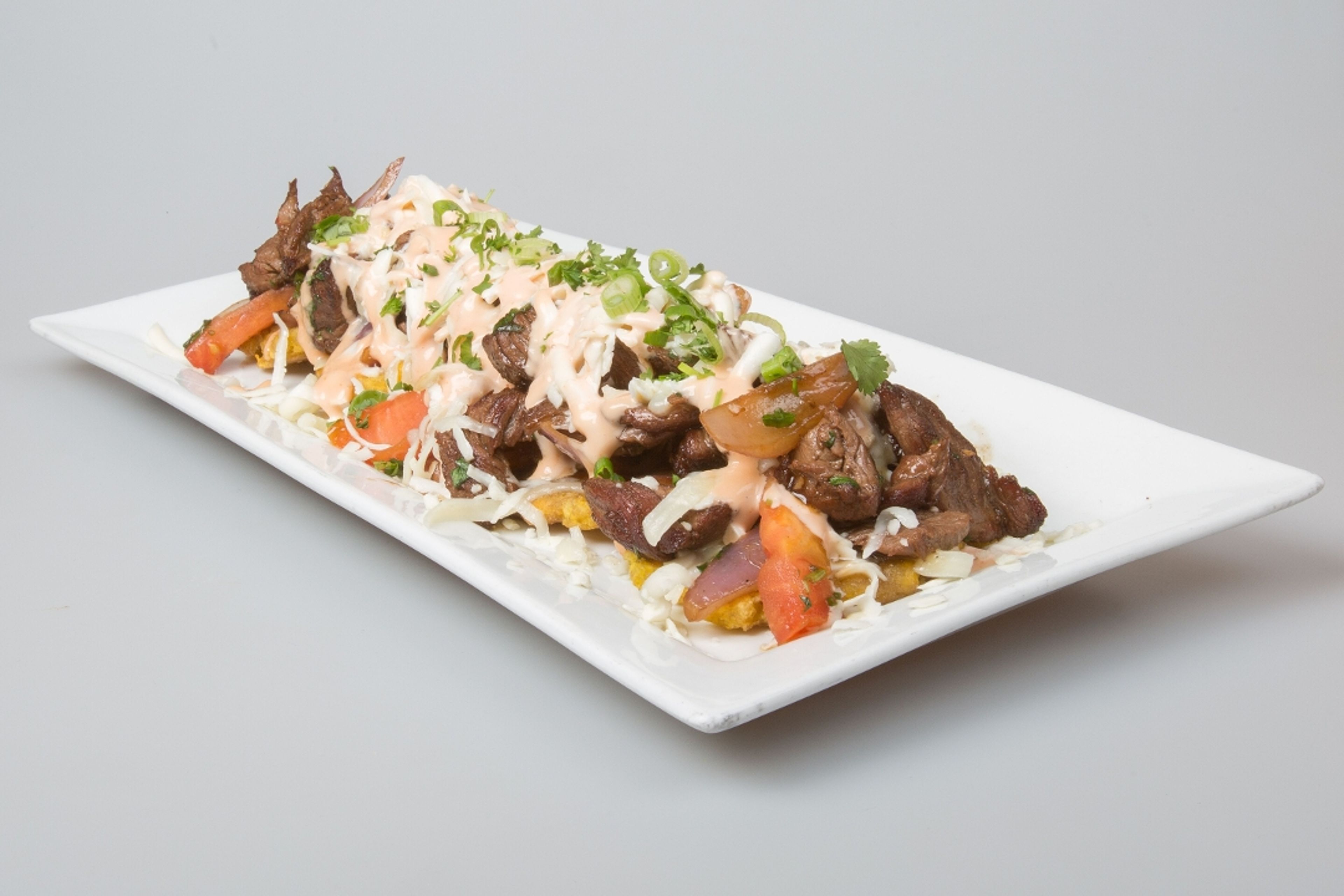 Fried Green Plantains With Wok Smoked Lomo Steak.