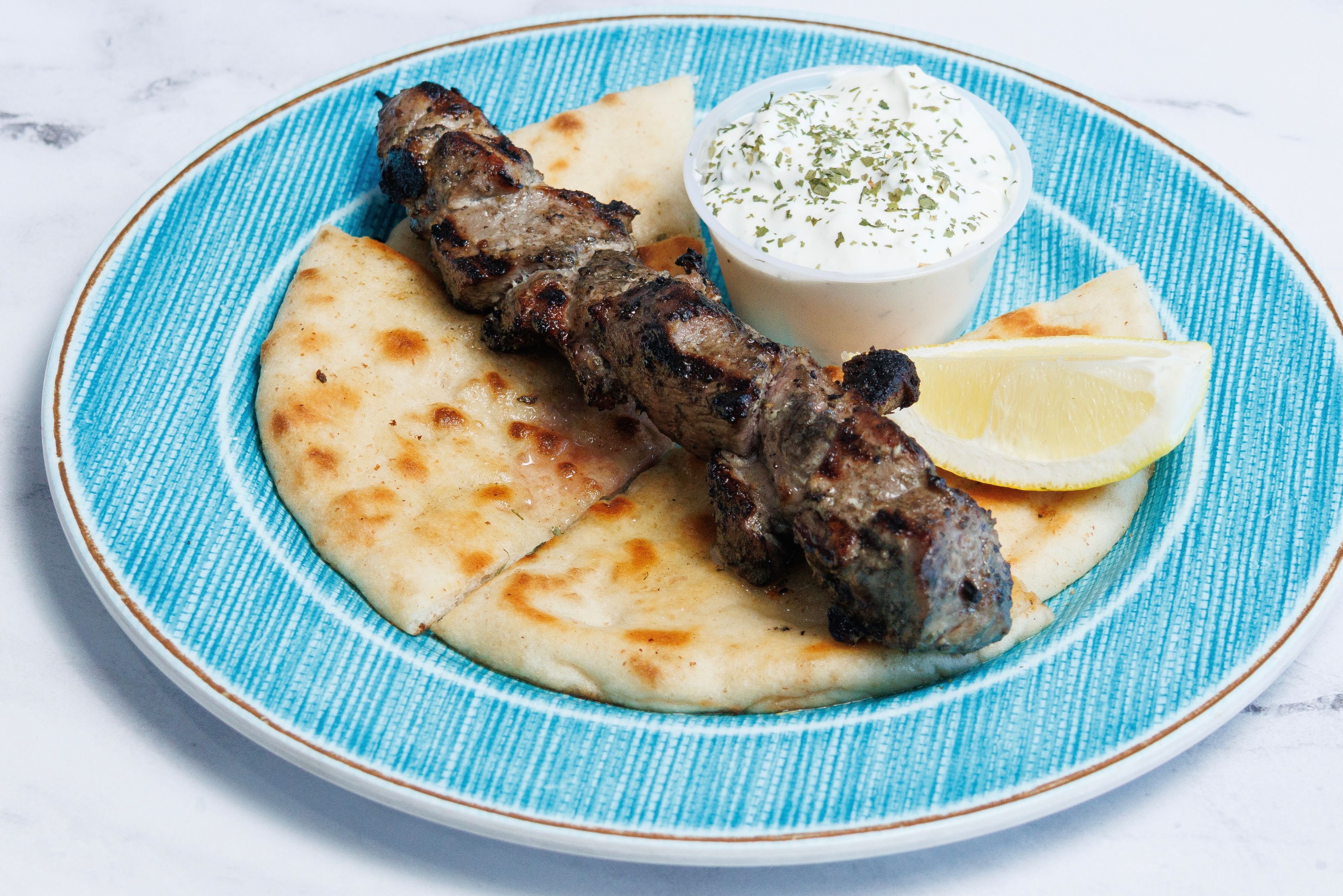 (1) PORK SOUVLAKI SKEWER W/ PITA & TZATZIKI.