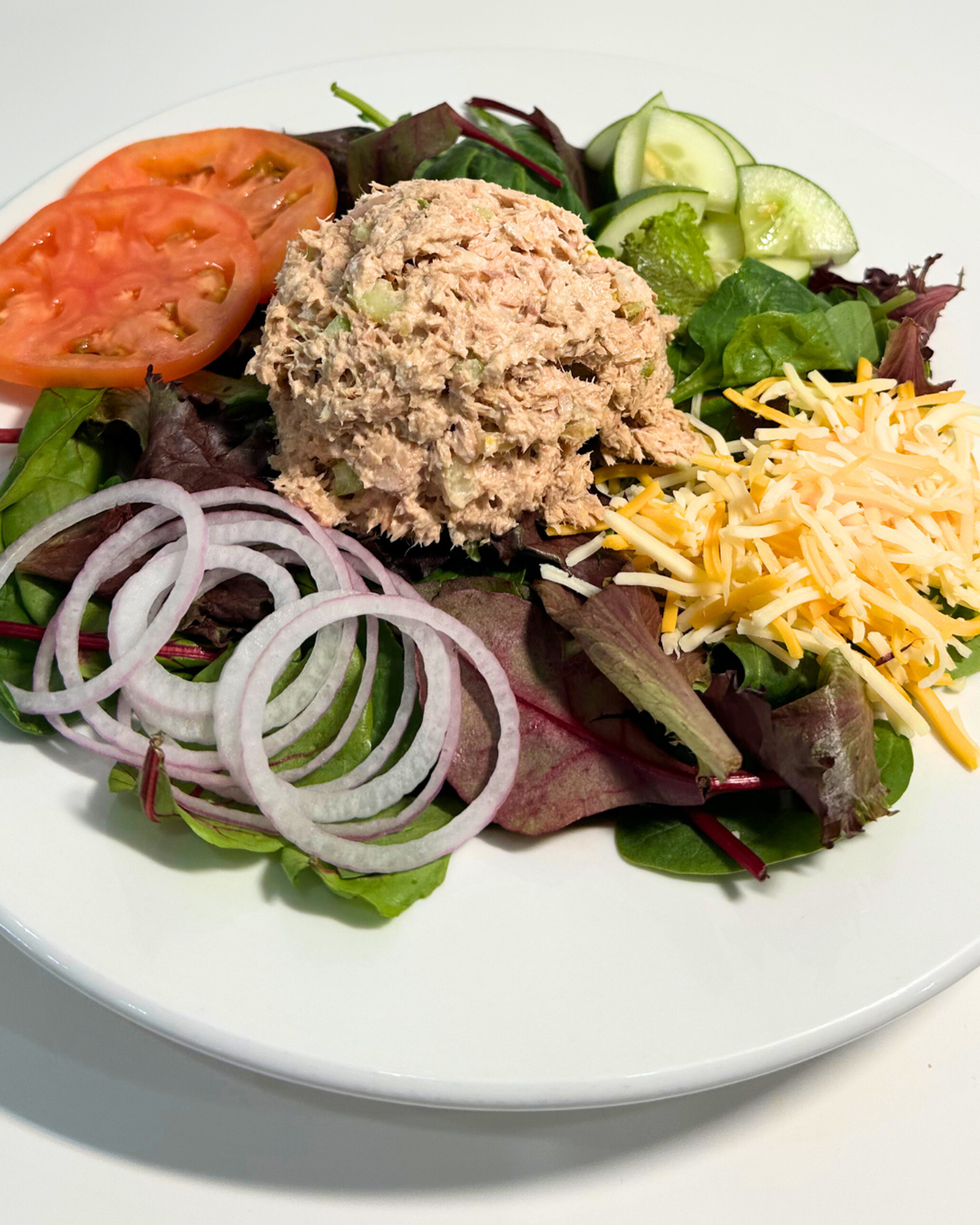 $ TUNA SALAD OVER MIXED GREENS.