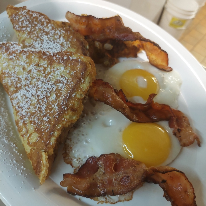 C. Two Large Eggs, Two Triangles Challah French Toast, Home Fries and Bacon or Sausage.