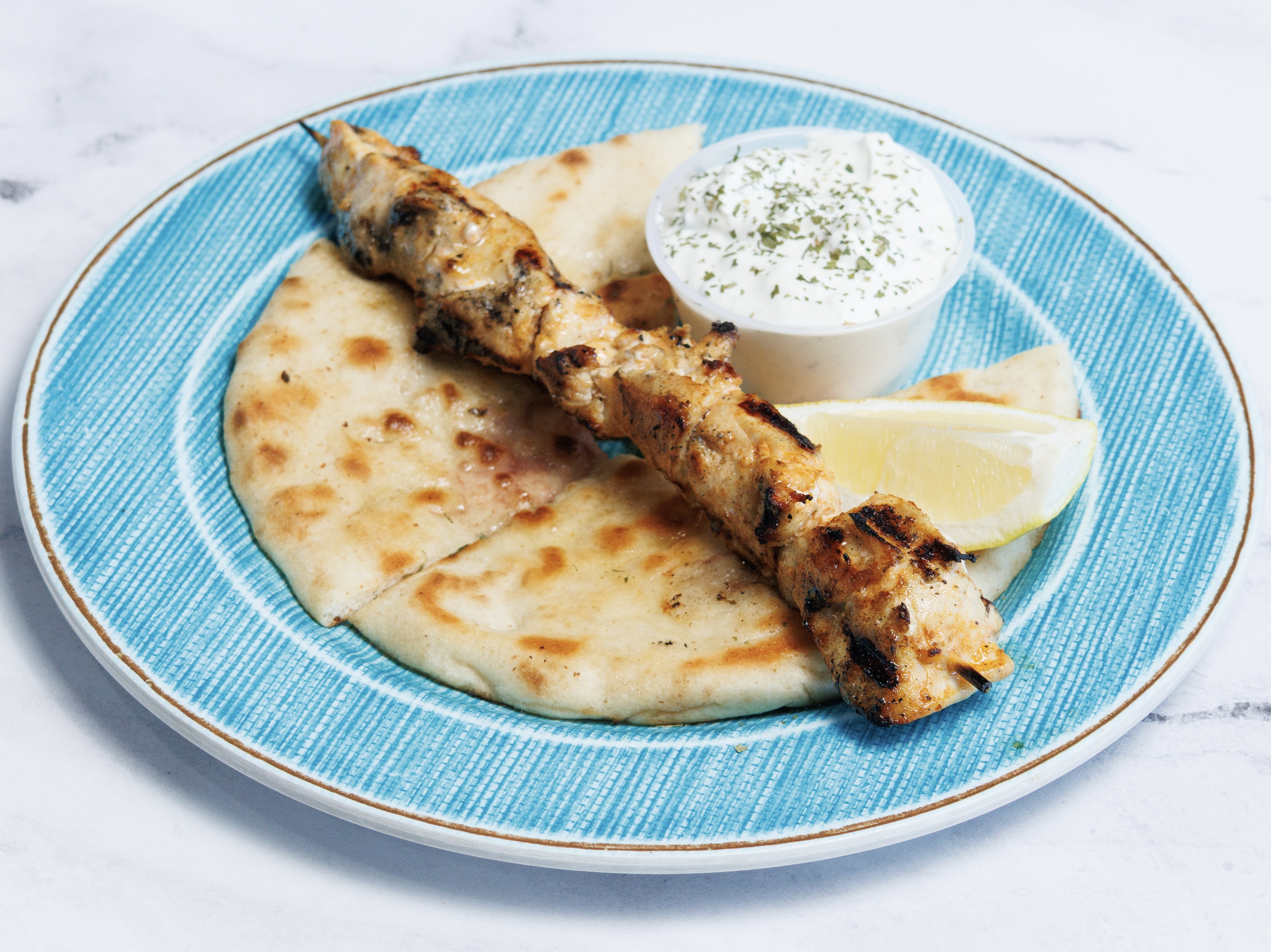 (1) CHICKEN SOUVLAKI SKEWER W/ PITA & TZATZIKI.