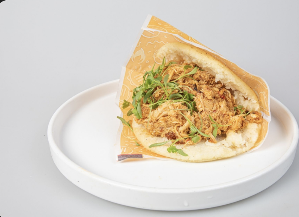 Arepa with shredded chicken.