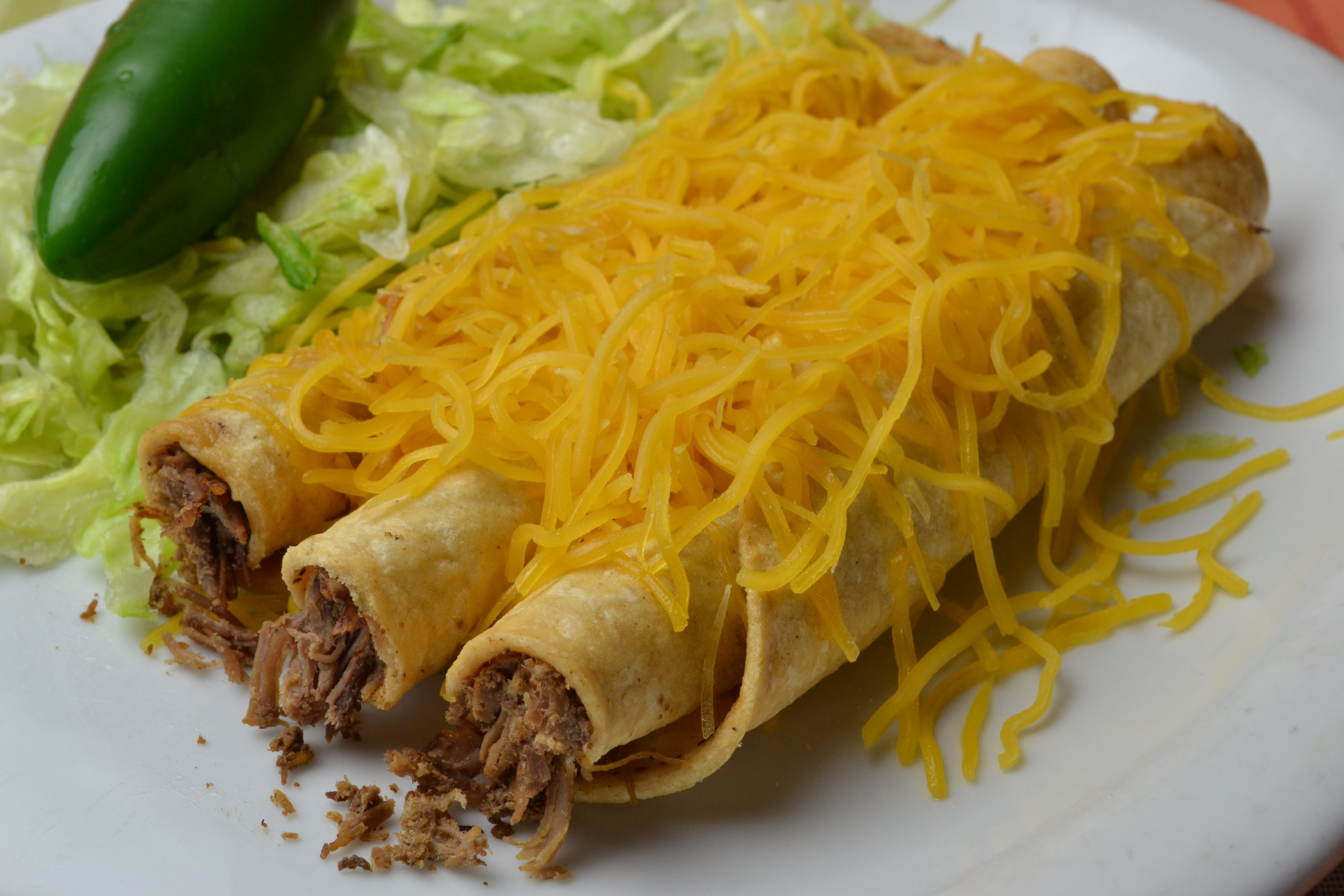3 Rolled Tacos with Cheese.