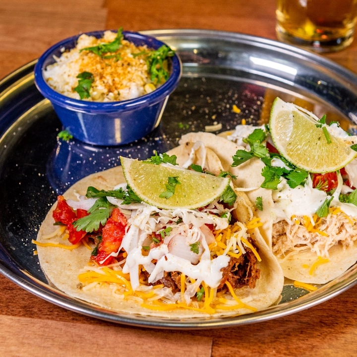2 Gourmet Tacos with rice & refried beans.