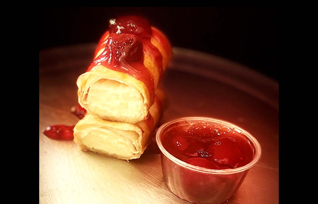 Cheesecake Burrito With Strawberry Sauce.