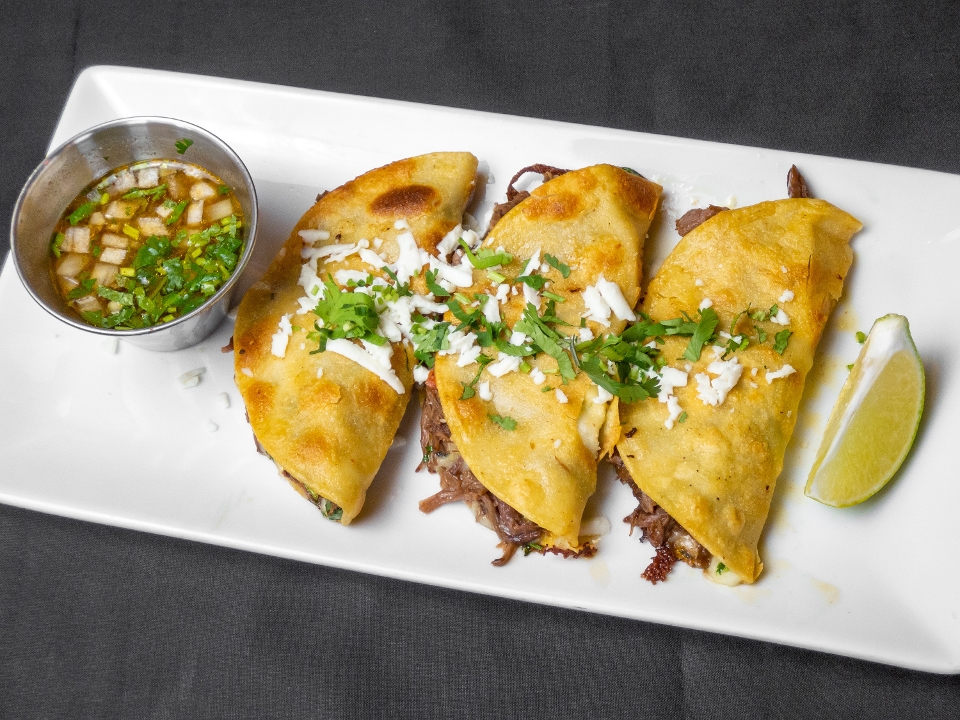 Birria Tacos On Flour Tortillas.