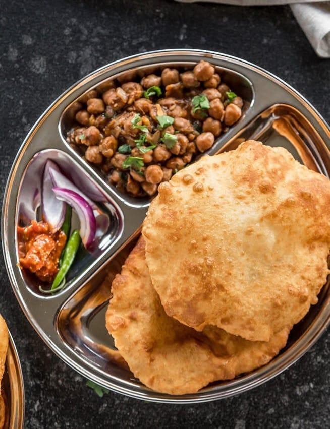 Chole Bhature (Pickle, Onion, Raita).