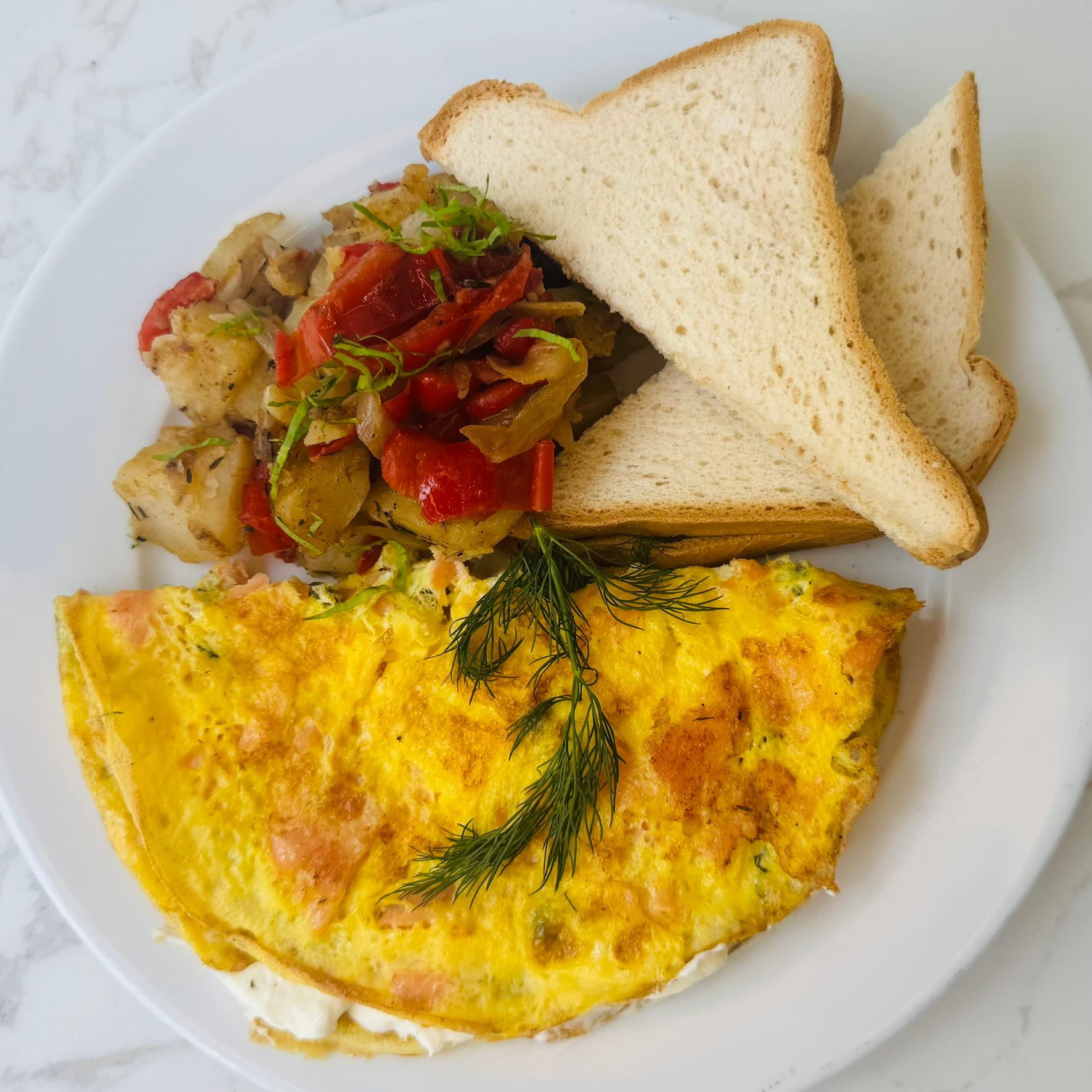 Smoked Nova Lox Omelette Deluxe, served with Home Fries and a Bagel.