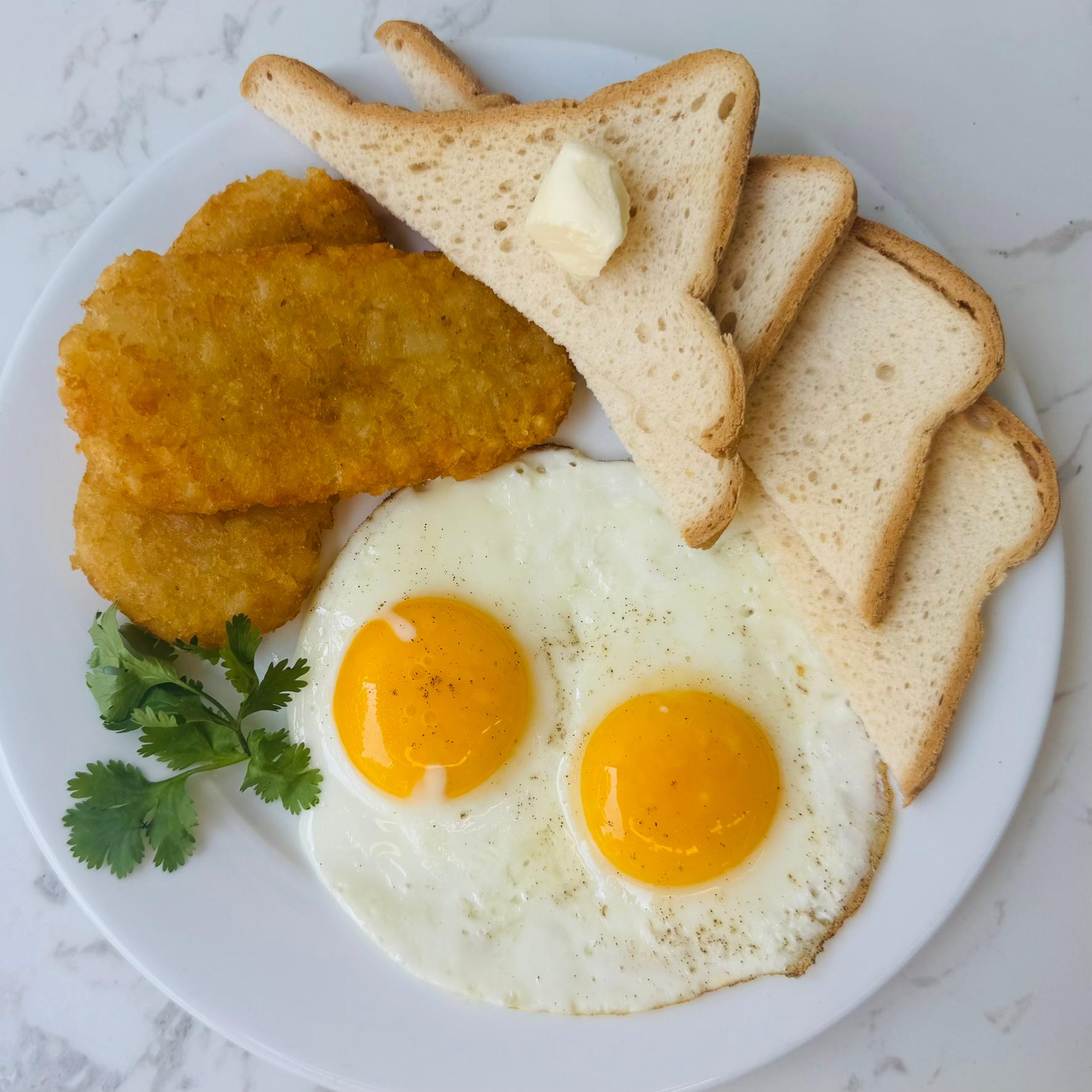 Two Eggs Any Style, served with Home Fries and a Bagel.