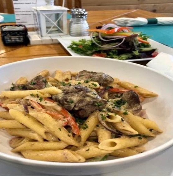 Grass Fed Filet Tips, Penne Pasta, Sauteed Peppers & Onions with Cajun Cream Sauce, Side Salad.