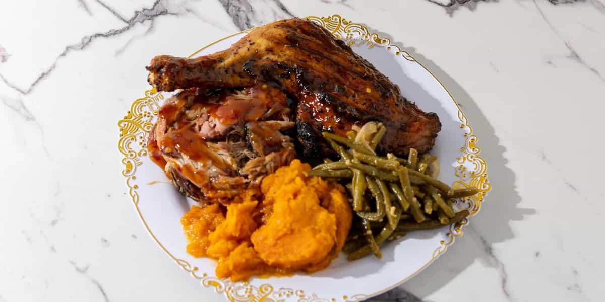 Chicken and Pulled Pork Combo with Two Sides.