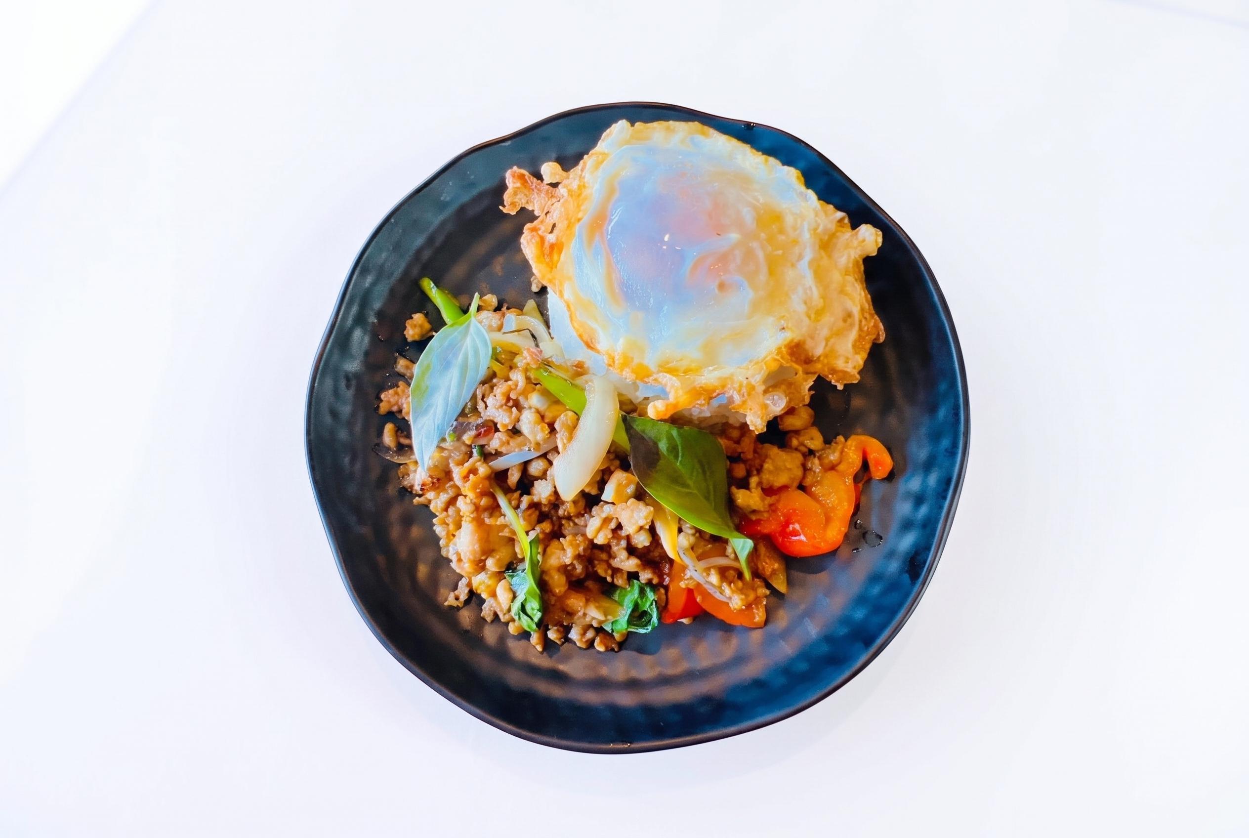 Ka-pow over rice with fried egg.