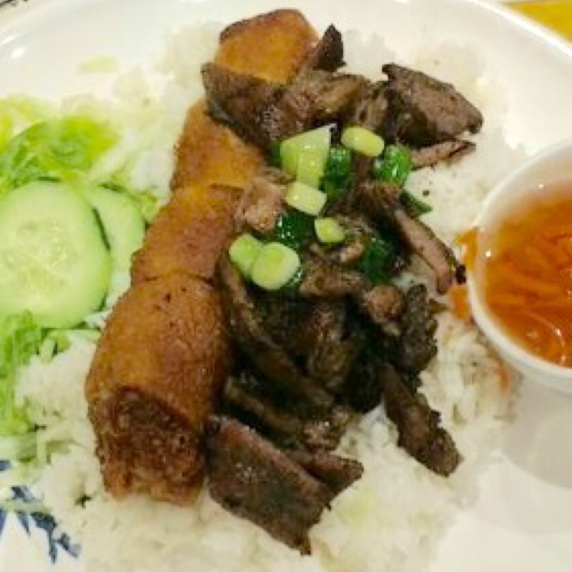 24. Imperial rolls with pork kebab over rice - cơm chả giò thịt nướng.