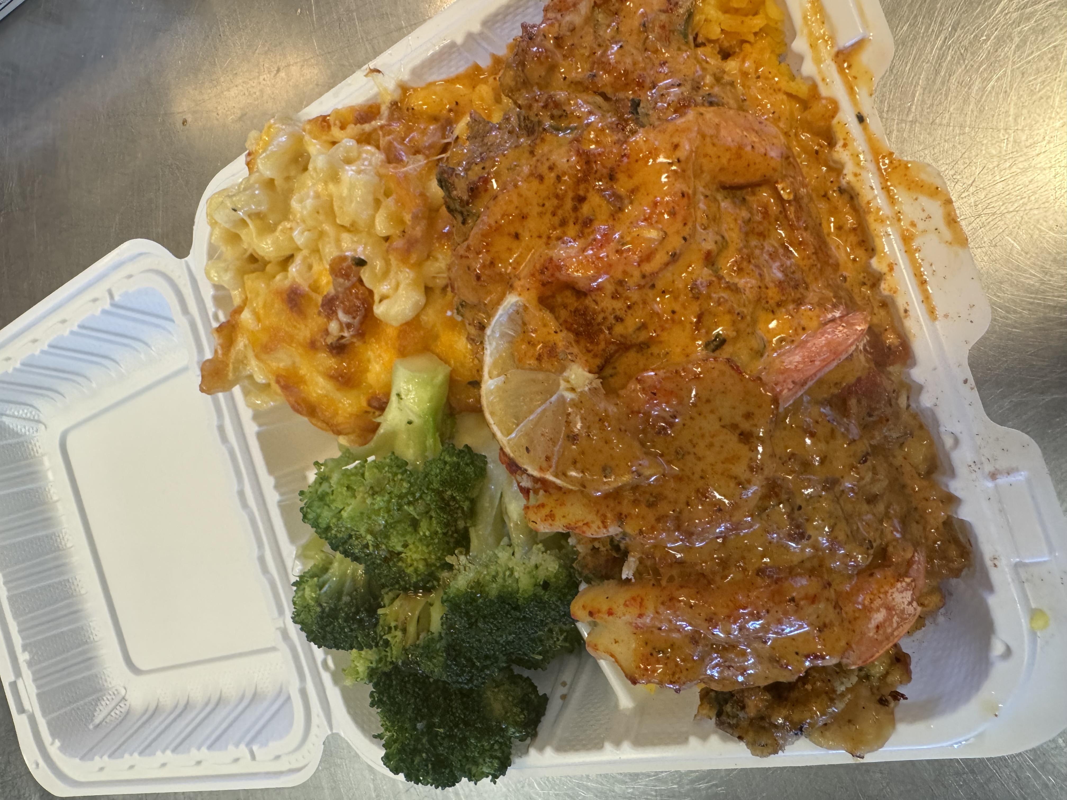 Baked stuffed Catfish with two sides and Cajun sauce.
