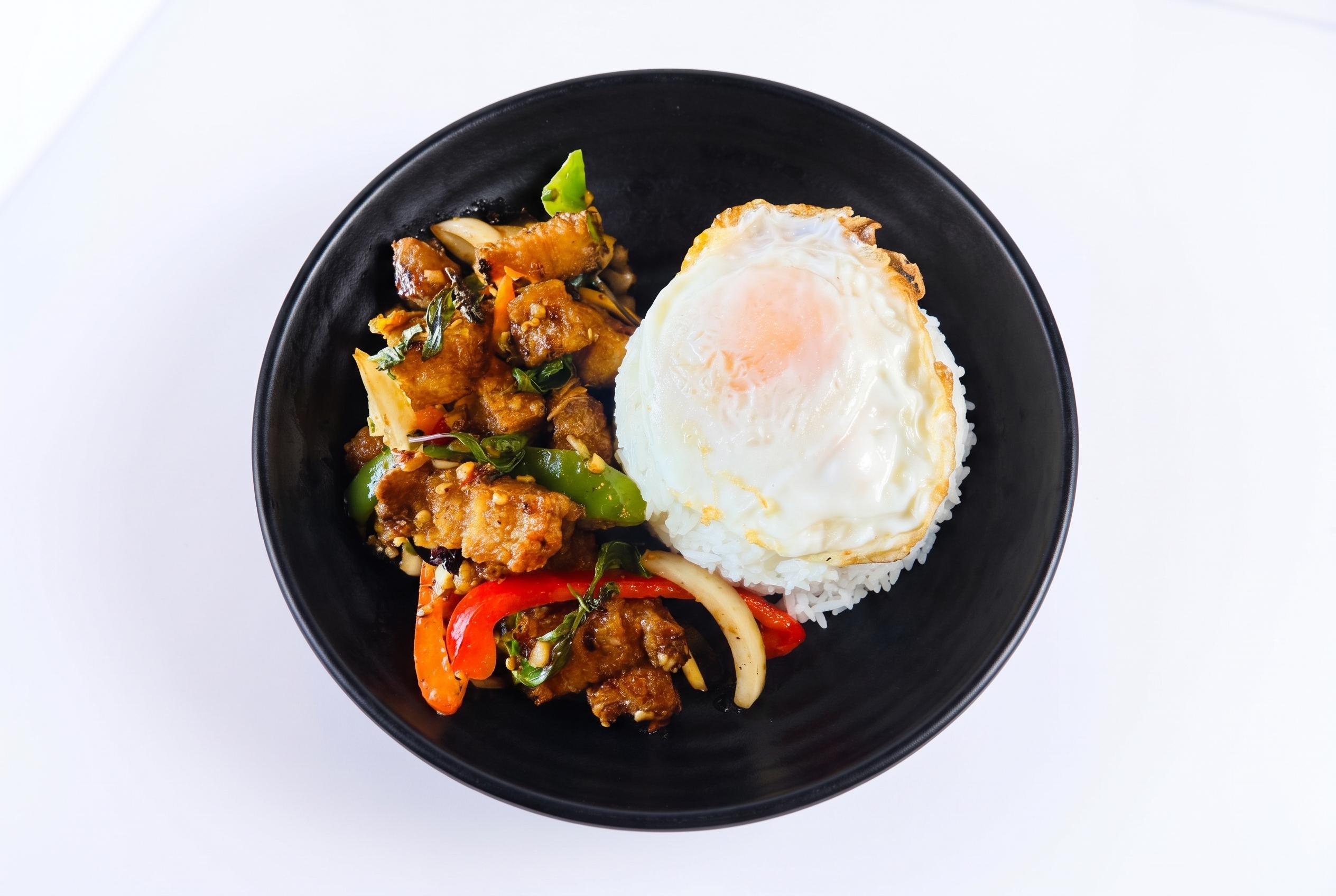 Crispy pork belly kra pow over rice w/fried egg.