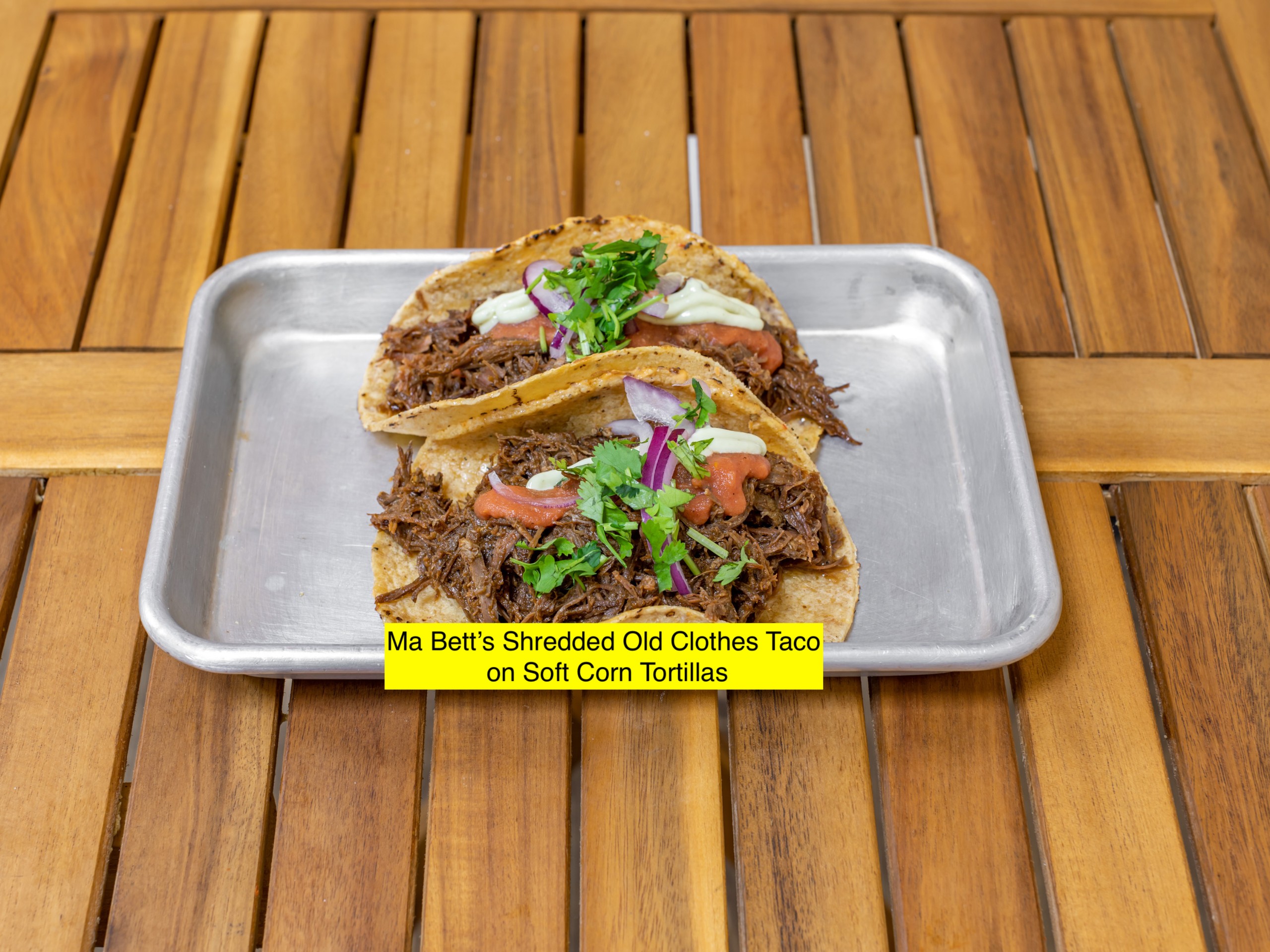 Ma Bett's Ropa Vieja Brisket Tacos, zhug mayo, roasted tomato salsa, pickled red onions, cilantro.