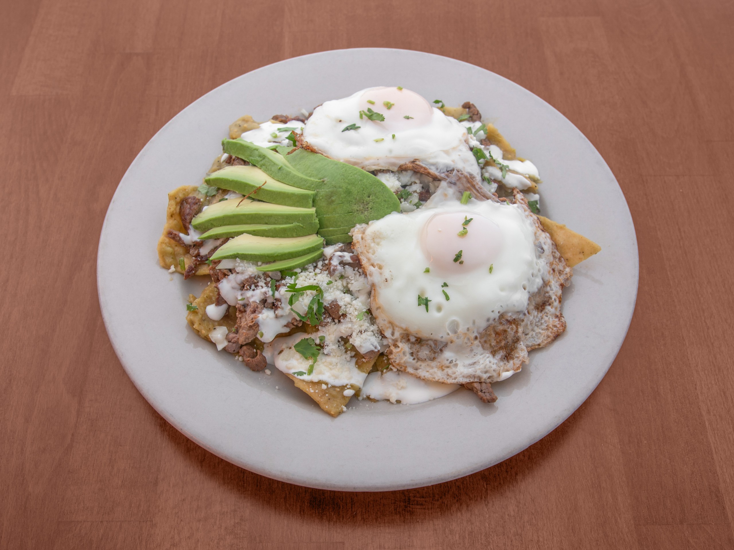 Chilaquiles Con Carne Y 2 Huevos Fritos / Chilaquiles with Meat and Two Fried Eggs.