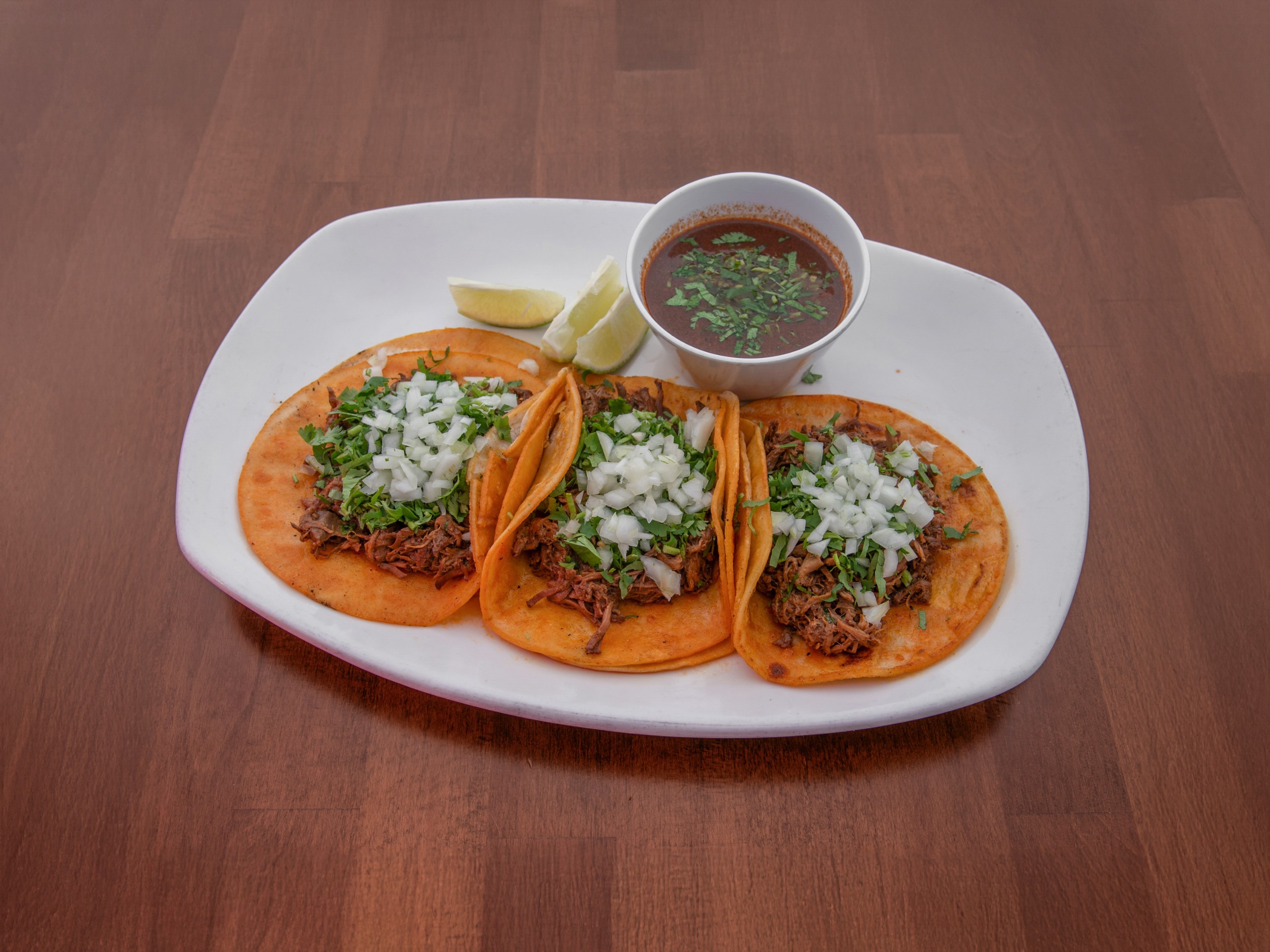 3 Porciones De Tacos De Birria Con Consomé / 3 Pieces of Birria Tacos with Consomme.