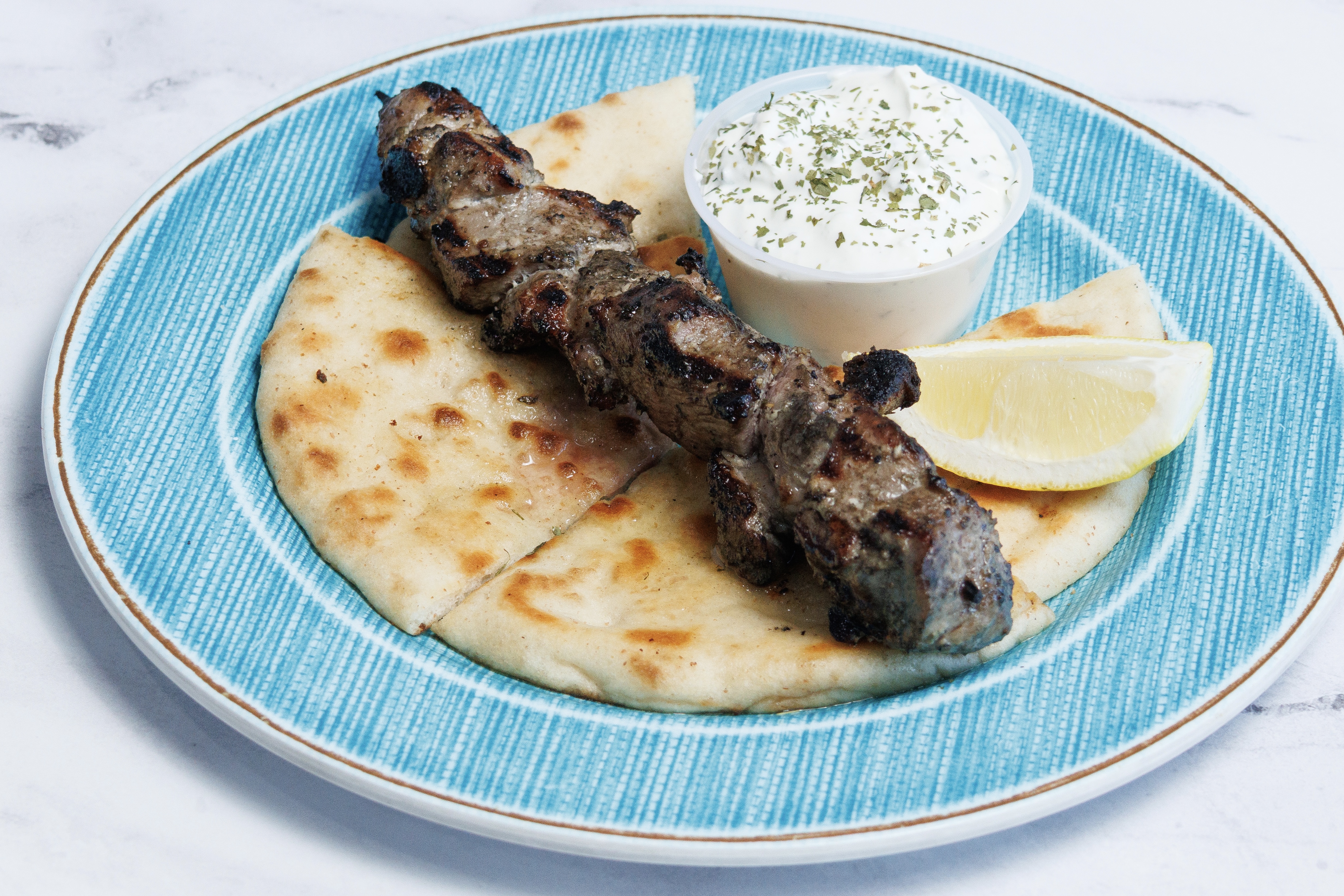 (1) PORK SOUVLAKI SKEWER W/ PITA & TZATZIKI.